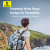 Person with a backpack featuring a patented wrist strap design, set against a scenic outdoor background.